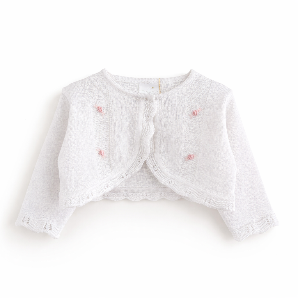 White long-sleeve knit communion bolero for girls with scalloped trim and pink embroidered details