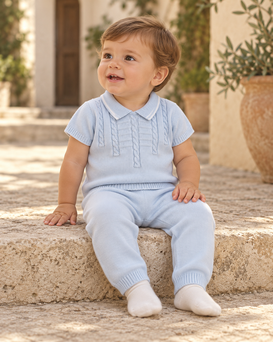 Light blue baby boy cotton knit set with a cable-knit polo top, white sleeve trim, and matching long pants by Dolce Goccia.