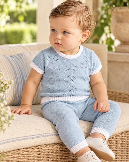 Baby boy wearing Dolce Goccia blue chevron knit cotton set with white trim