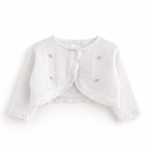 White long-sleeve knit communion bolero for girls with scalloped trim and pink embroidered details